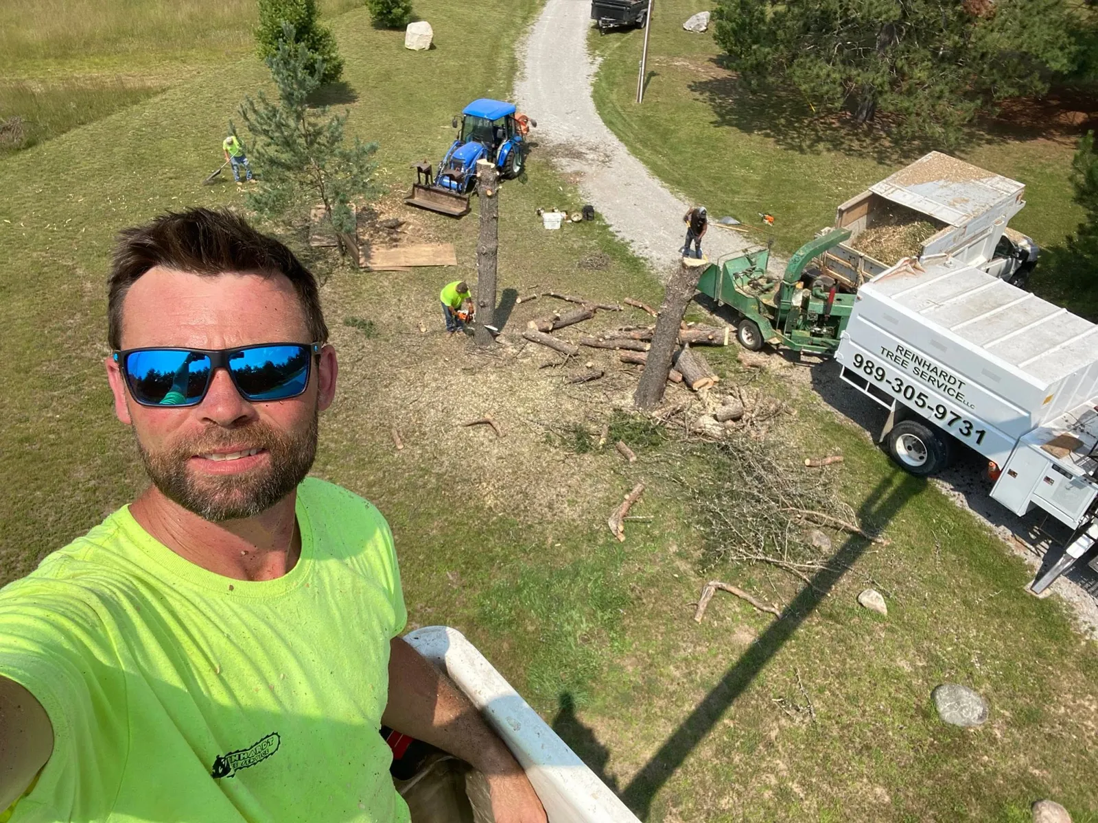 Tree removal: Larry in the bucket, crew and chipper below